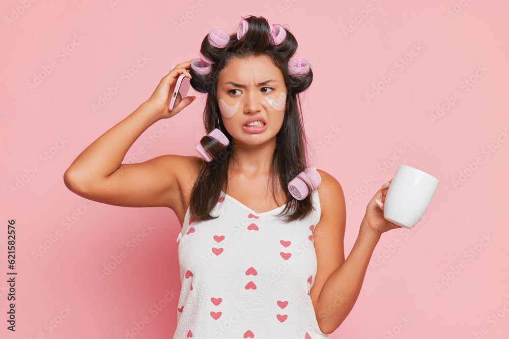 Female student in white top going to university, doing morning routines, curling up hair and drinking coffee, morning mood concept, copy space Female student in white top going to university, doing morning routines, curling up hair and drinking coffee, morning mood concept, copy space