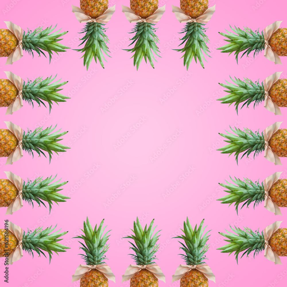 Bonbon candy frame made of pineapple fruit with pink bows on pastel pink background. Original summer design. Minimal fruit concept. Creative advertisement idea. Fruit candy. Copy space, template.