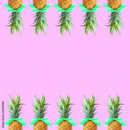 Bonbon candy frame made of pineapple fruit with mint bows on pastel pink background. Original summer design. Minimal fruit concept. Creative advertisement idea. Fruit candy. Pineapple bonbon. 