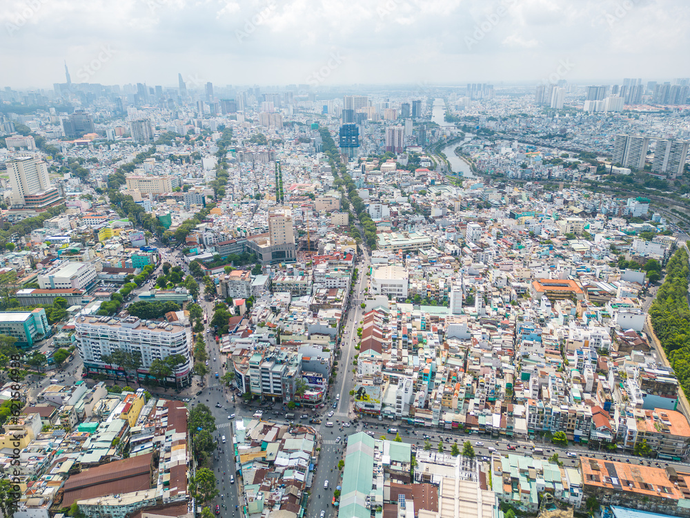 Obraz premium Aerial view of Ho Chi Minh City skyline and skyscrapers in center of heart business at Ho Chi Minh City downtown. Cityscape and many buildings, local houses