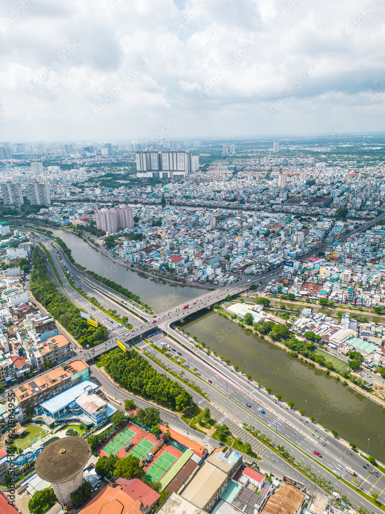 Fototapeta premium Aerial view of Ho Chi Minh City skyline and skyscrapers in center of heart business at Ho Chi Minh City downtown. Cityscape and many buildings, local houses