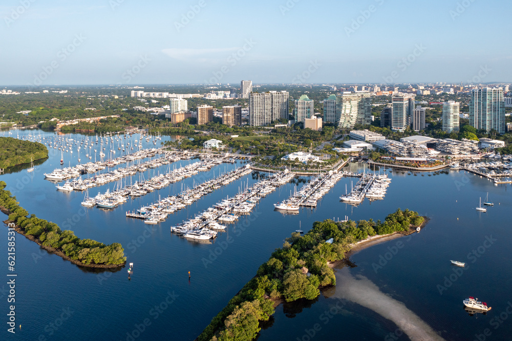 Aerial view of Dinner Key Marina and City of Miami City Hall with Coconut Grove, Miami skyline in background on calm sunny clear summer morning.