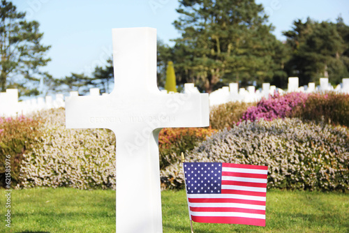 Grave cross, with flag, tribute to soldier, in American cemetery in Normandy. Second World War