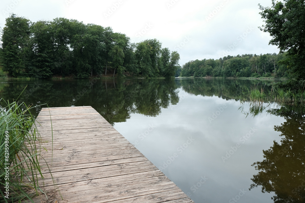 calm pier on a peaceful wood lake