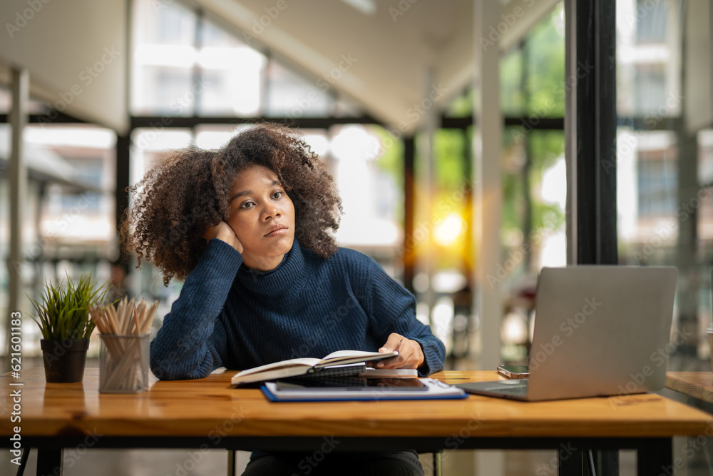 business woman sitting absent-minded Pondering while taking a break from the job in front of her. feeling bored and tired business woman sitting absent-minded Pondering while taking a break from the job in front of her. feeling bored and tired