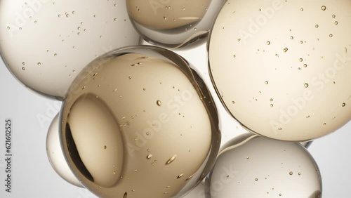 Cosmetics golden serum liquid bubbles abstract background. Cosmetic moisturizer essence gel. Collagen fluid bubble molecule. Moisturizing cream or oil for personal health care and beauty skin concept