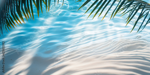 palm leaf shadow on abstract white sand beach Background, sun lights on water surface, beautiful abstract background concept banner for summer vacation at the beach