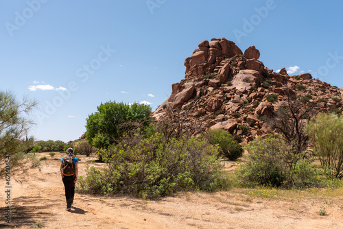A hiker at the famous Napoleon Hat in the Tafrout valley in the Anti-Atlas mountains photo