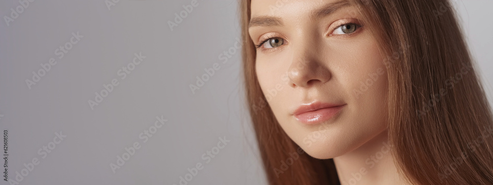 Naklejka premium Perfect skin. Face wellness. Facial cosmetics. Beautiful flawless confident smiling fair hair woman with natural makeup isolated on beige background empty space.