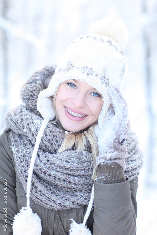 Happy blonde girl in a winter scenery with a hat and gloves. Happy blonde girl in a winter scenery with a hat and gloves.