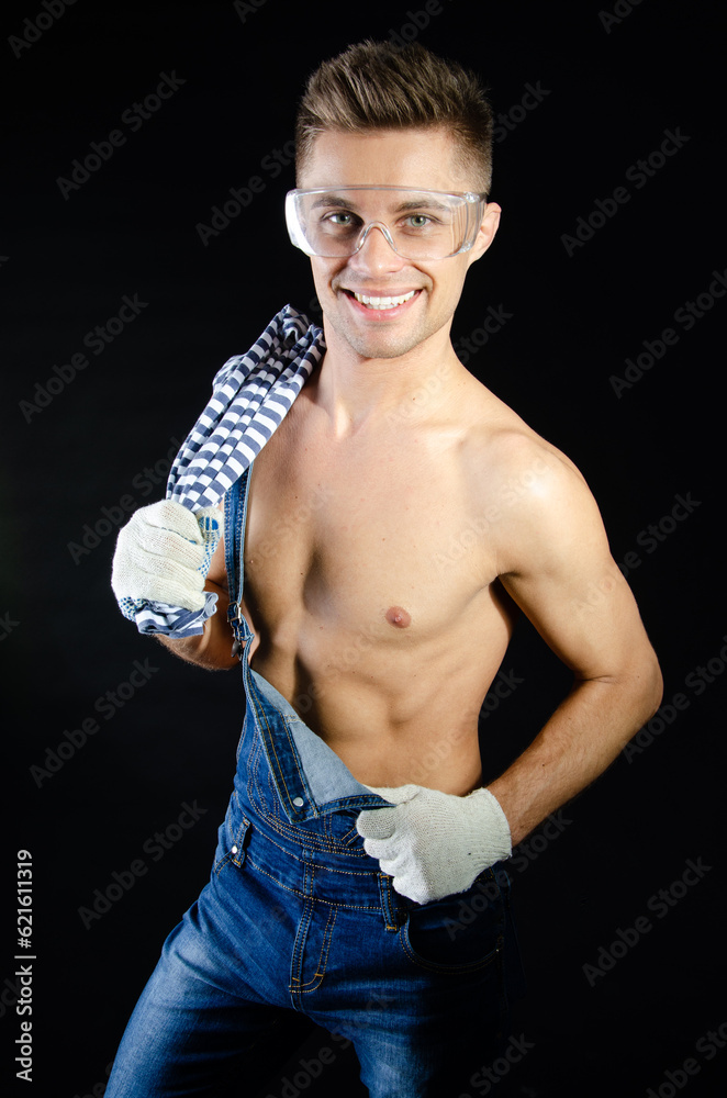Young attractive handyman posing in a photo studio.