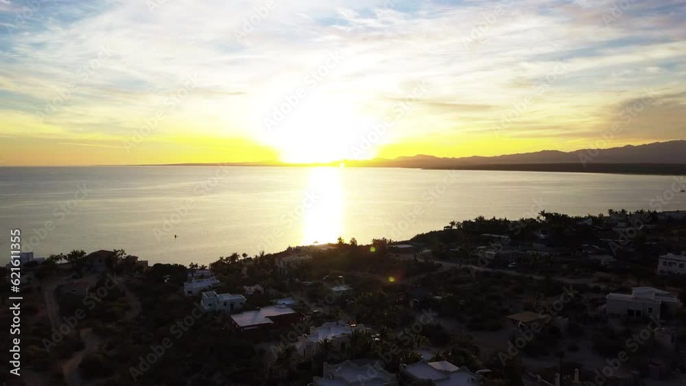 Aerial Shot Of Buildings Near Sea And Mountains Against Sky, Drone Flying Backward Over City At Sunset - Baja California, Mexico Aerial Shot Of Buildings Near Sea And Mountains Against Sky, Drone Flying Backward Over City At Sunset - Baja California, Mexico