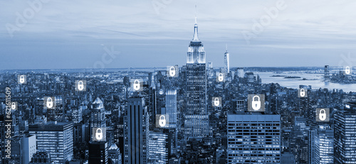 Cybersecurity lock and diverse network icons hologram. New York blurred cityscape. Concept of cybersecurity and data privacy.