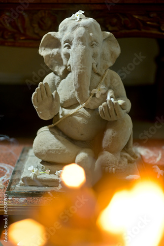 Canvastavla Handmade clay sculpture of Hindu God Ganesha being worshiped during Ganesh festival, India