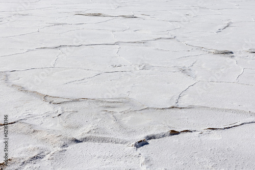 Exploring the huge salt flats Salinas Grandes de Jujuy in northern Argentina while traveling South America - close up of the surface photo