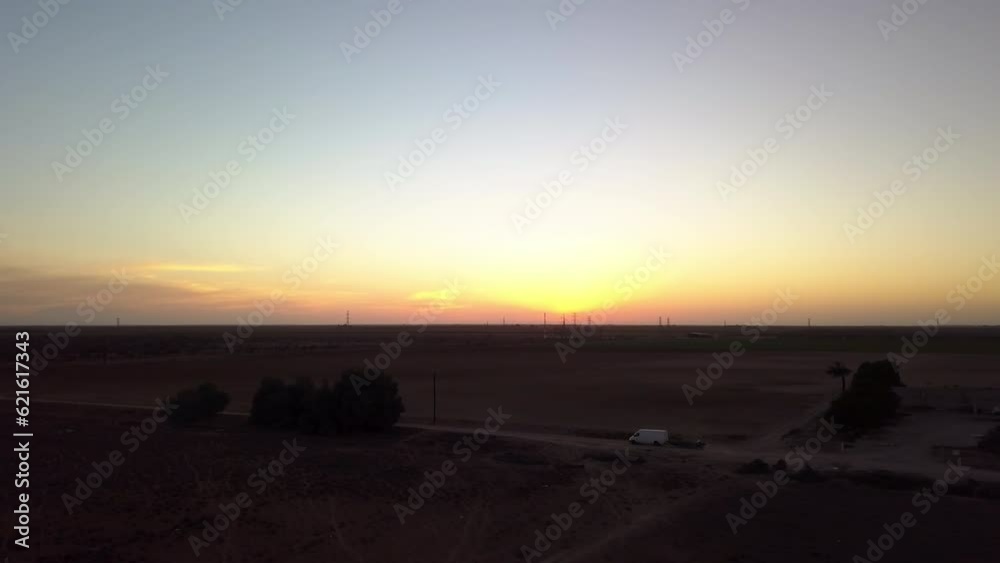 Aerial Panning Shot Of Vehicle With Trailer On Road By Field Against Sky, Drone Flying Over Rural Landscape At Sunset - Baja California, Mexico Aerial Panning Shot Of Vehicle With Trailer On Road By Field Against Sky, Drone Flying Over Rural Landscape At Sunset - Baja California, Mexico