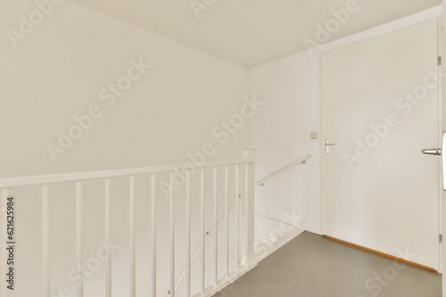 an empty room with white walls and wooden floors  there is a mirror hanging on the wall in the corner