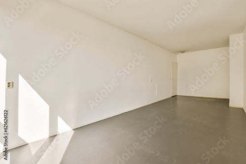 an empty room with light coming in through the window and shadows on the wall behind it, taken from above