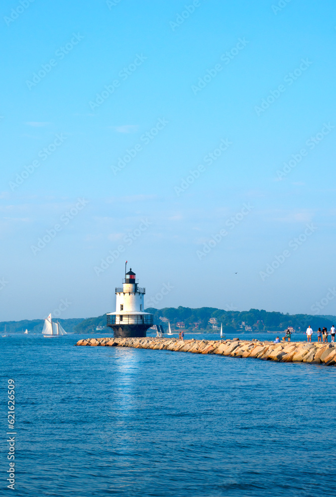Spring Point lighthouse on a warm summer evening in Portland Maine. Windjammers, favorite tourist attraction 