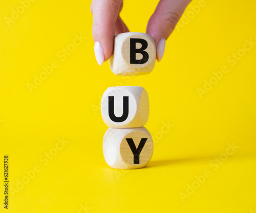 BPM - Business Process Management symbol. Wooden cubes with words BPM. Businessman hand. Beautiful yellow background. Business and BPM concept. Copy space.