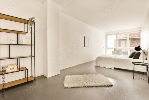 Bilde på lerret a bedroom with a bed and shelves on the wall next to the bed is a white rug that