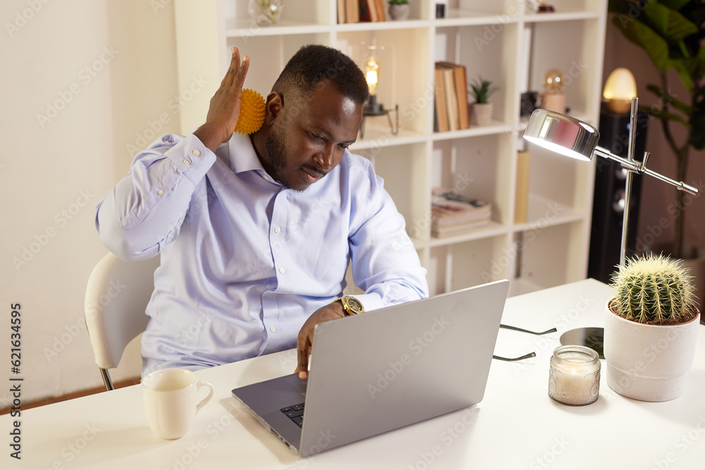 Employee Stretching At Office Desk At Work, tired African American office worker Employee Stretching At Office Desk At Work, tired African American office worker