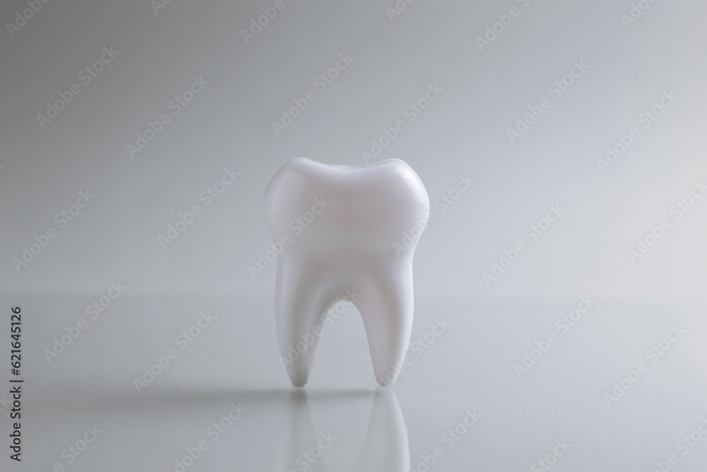 Dentistry concept. Model of a tooth and dental instruments on a light background with space for text. Dentistry concept. Model of a tooth and dental instruments on a light background with space for text.