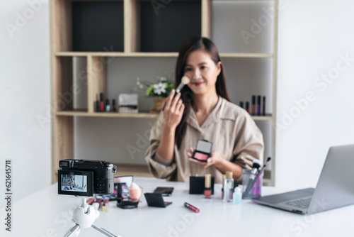 Happy smiling elegant woman or beauty blogger with brush on reco