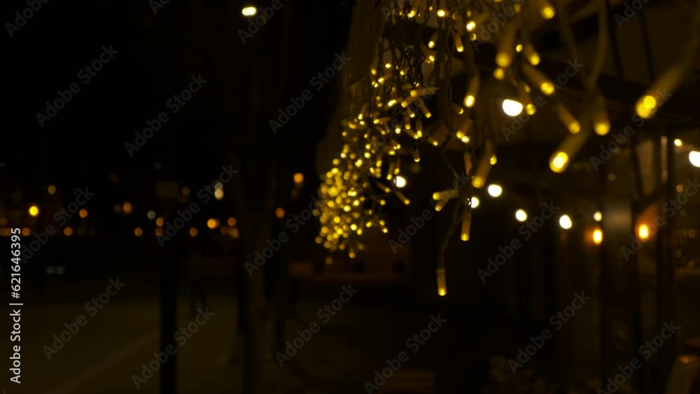 Street caffee facade in garlande. A bright decorative garlande on the caffee facade in the city during night time.