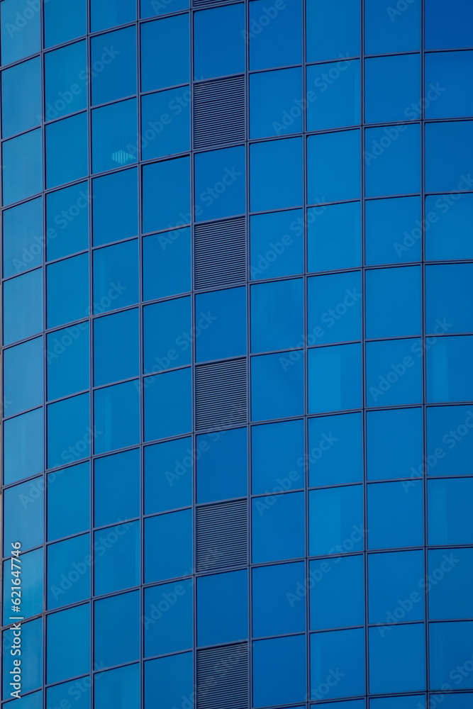 Glass wall of a skyscraper. Mirrored wall of a high-rise building. Glass wall of a skyscraper. Mirrored wall of a high-rise building.