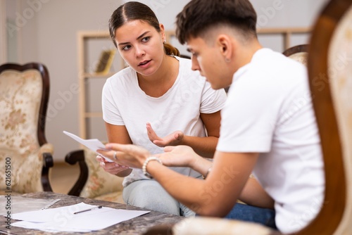 Female realtor helping young man fill out paperwork