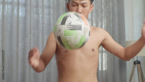 Close Up Of Asian Teenager Boy Doing Football Skills During The Shirtless Workout At Home
