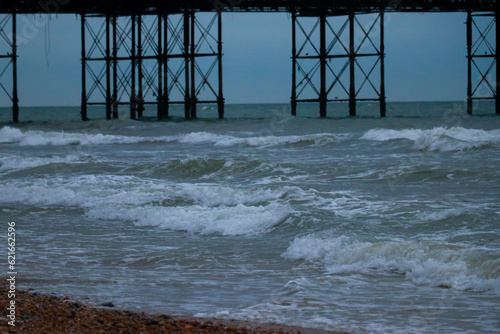 big wooden pier with a sea in a dark afternoon