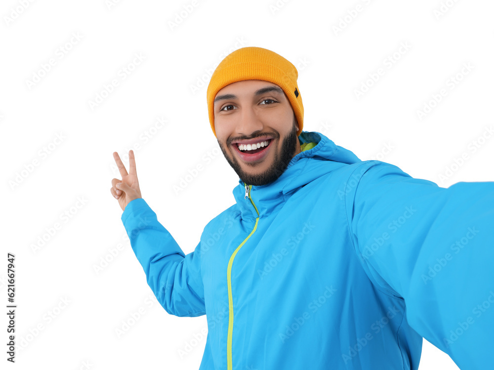 Smiling young man taking selfie and showing peace sign on white background Smiling young man taking selfie and showing peace sign on white background