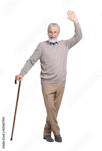 Senior man with walking cane waving on white background