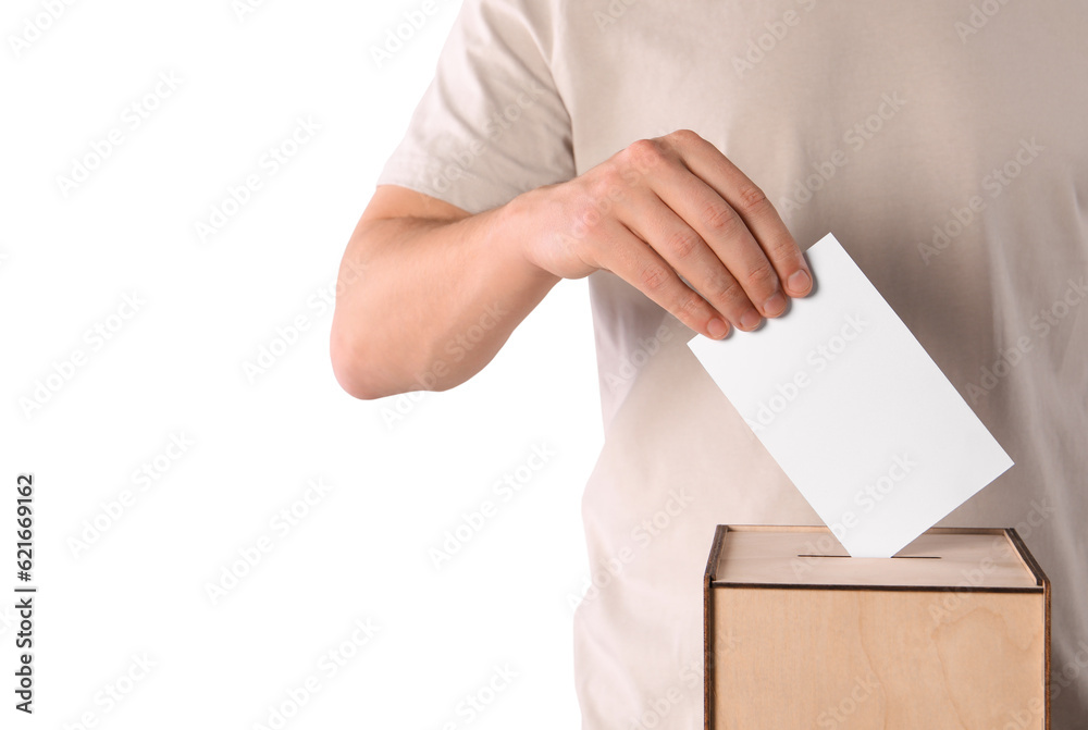 Man putting his vote into ballot box on white background, closeup Man putting his vote into ballot box on white background, closeup