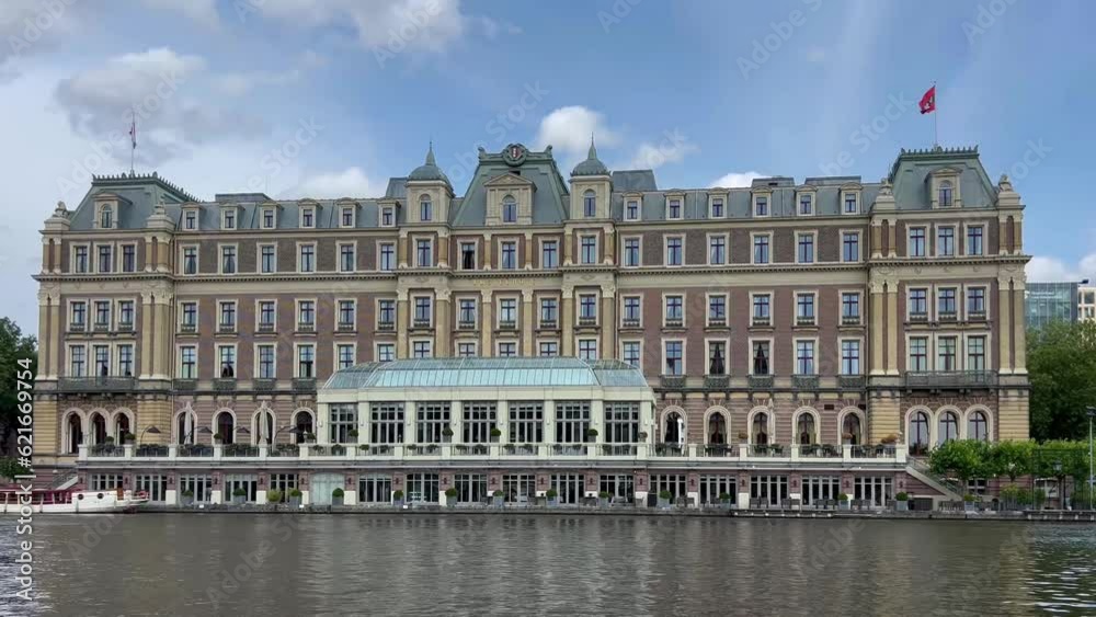 Traditional old narrow houses boats and canals Amsterdam, Netherlands, Europe, July 5 2023 . High quality 4k footage Traditional old narrow houses boats and canals Amsterdam, Netherlands, Europe, July 5 2023 . High quality 4k footage