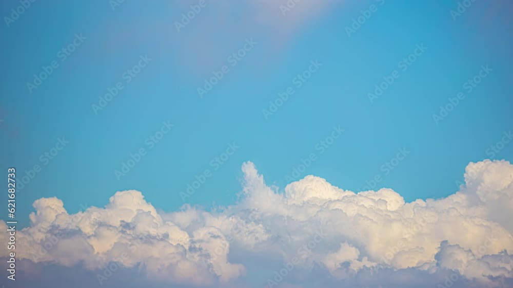 White clouds passing through a blue sky. Time lapse shot