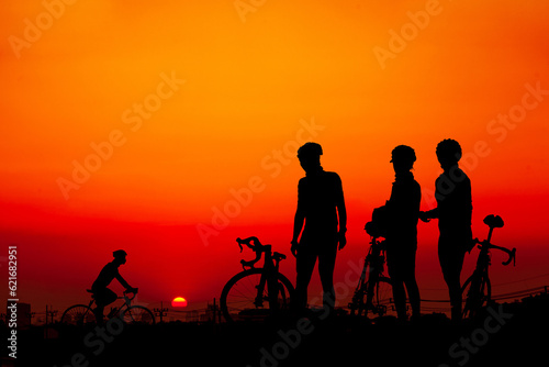 Silhouette of a mountain biker enjoying downhill during the sunset.