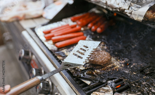 Sizzling skewers of beef, pork, chicken, and shrimp grilling over an open flame, representing indulgence, gathering, and culinary delights hot dogs and hamburgers too 