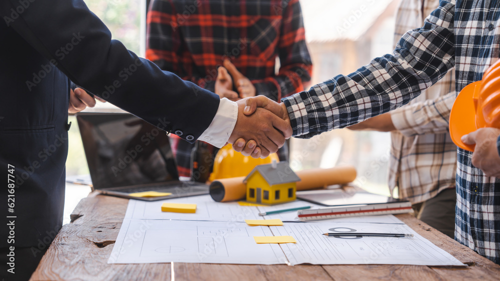 Shaking hands, Factory Meeting Room of architect engineer meeting at working desk of blueprints construction concept. Engineer people concept Shaking hands, Factory Meeting Room of architect engineer meeting at working desk of blueprints construction concept. Engineer people concept