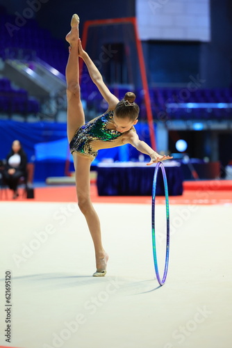 Rhythmic gymnastics in the professional arena. Performance with the hoop in front of the audience