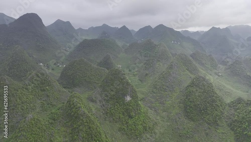 HDR drone video of rounded green mountains in Northern Vietnam near Dong Van on the Ha Giang Loop