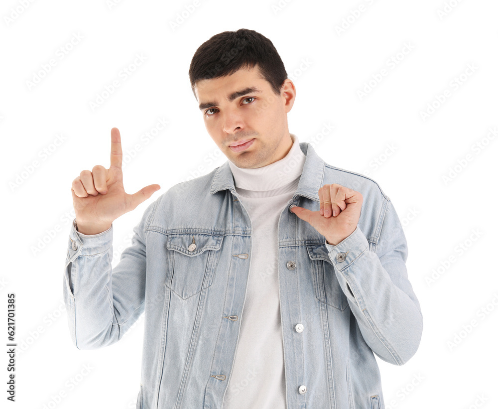 Upset young man showing loser gesture on white background Upset young man showing loser gesture on white background