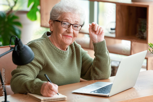 Senior woman working with l...