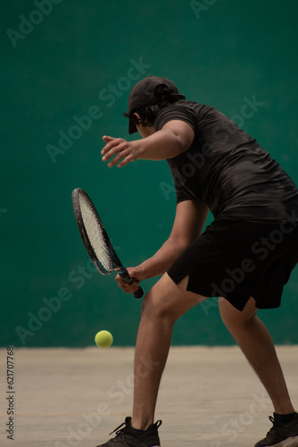 frontenis player with good technique of hitting a low short ball