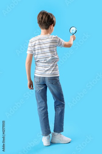 Little boy with magnifier o...