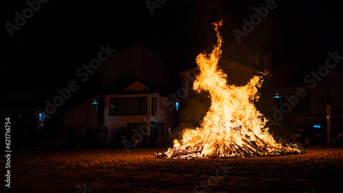 rural celebration with the hole town watching the fire of a bonfire