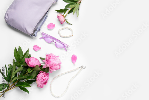 Composition with stylish female accessories and beautiful peony flowers on white background