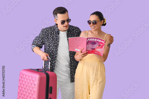 Young couple with magazine ...